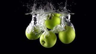 super-slow-motion-video-falling-four-green-apples-and-splashes-of-water_bxq6n5xg__S0000